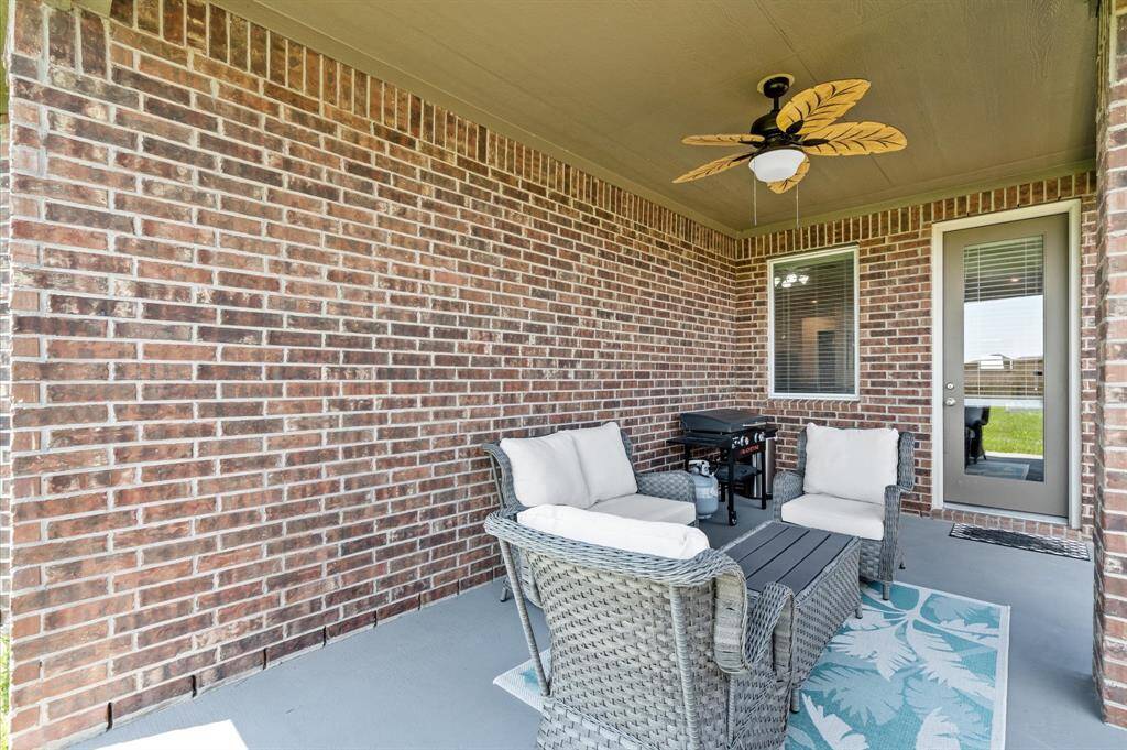 A charming covered patio rests just off the family room. Stay cool under the ceiling fan as you relax with a cold beverage.