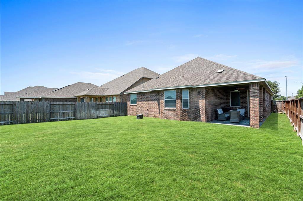 The side yards on either side of the home offer space to store outdoor equipment or possibly to create a dog run.