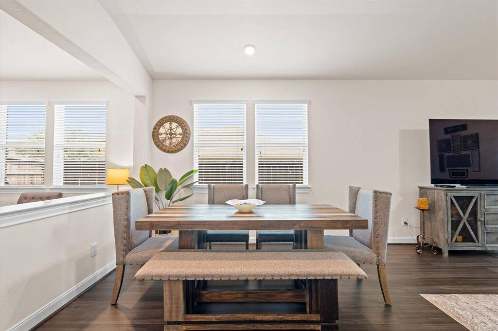 A half wall separates the combination family room and dining room from the formal living room.