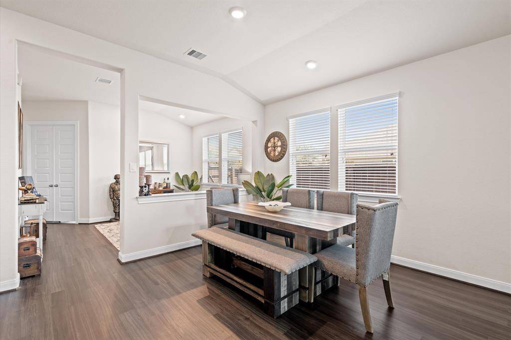 From the family room looking toward the dining area. Notice the formal living room on the other side of the half wall. The closed double doors on the left open to a study.