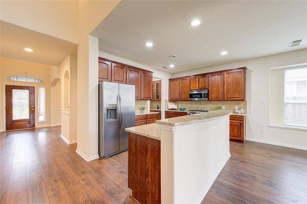 The kitchen is a host’s dream with designated breakfast bar area.