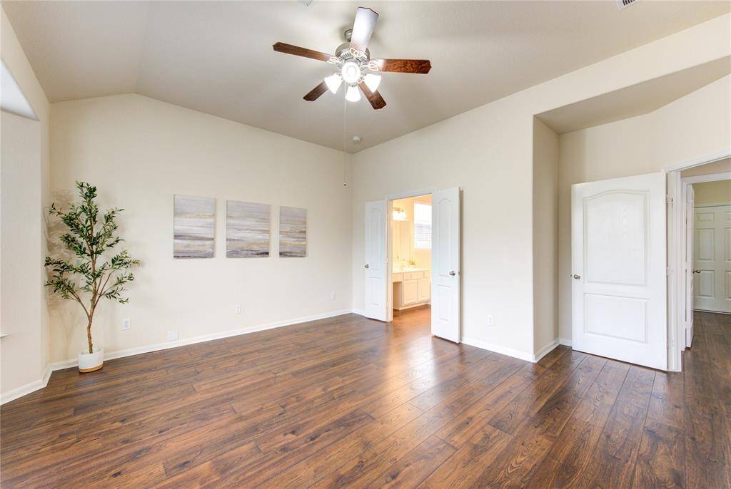 Creamy paint and striking wood floors combine to make this space welcoming and inviting.