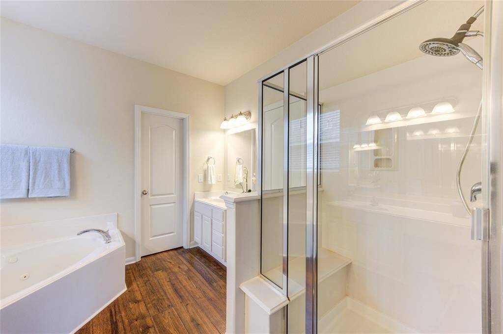A glass-enclosed shower mimics the luxury and attention to detail found throughout the rest of this property.