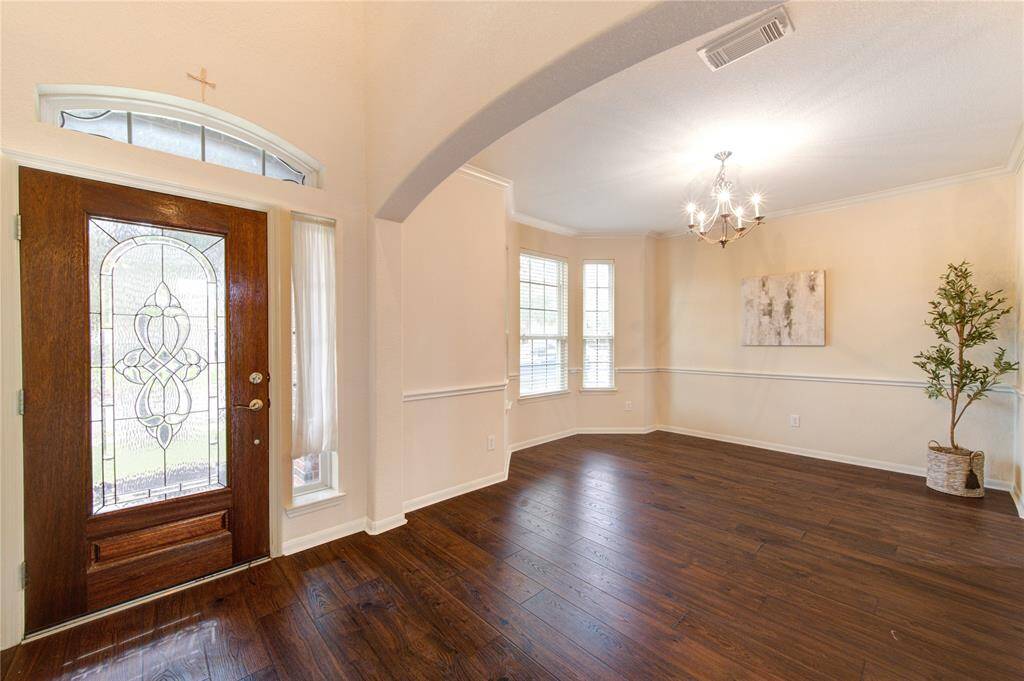 This home showcases its masterful design in the attention to detail. Notice the intricate designs on the front door, and the continuous arches throughout the house.