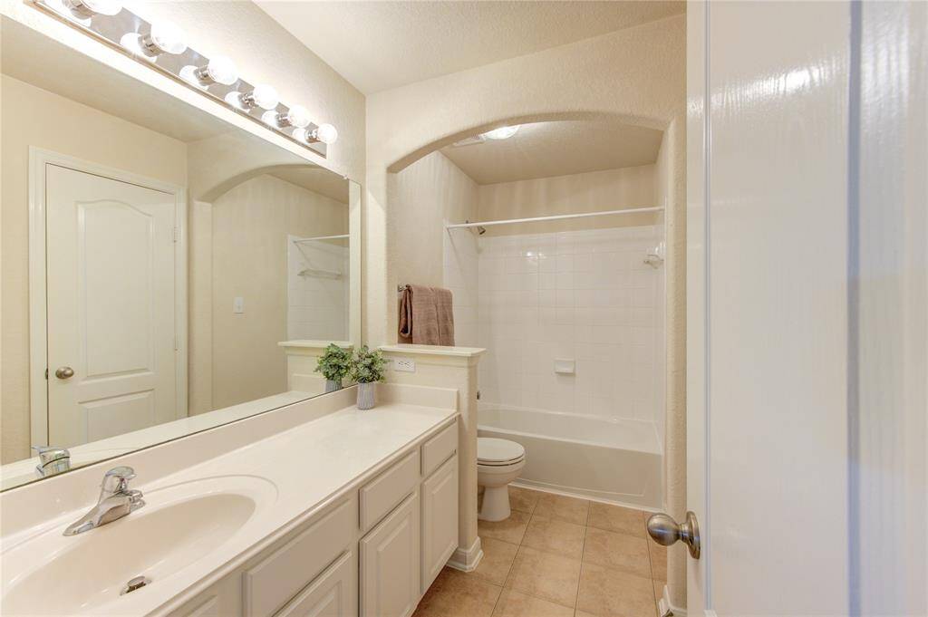 This clean and attractive space is perfect for family and guests alike. A large vanity provides room for all the essentials.