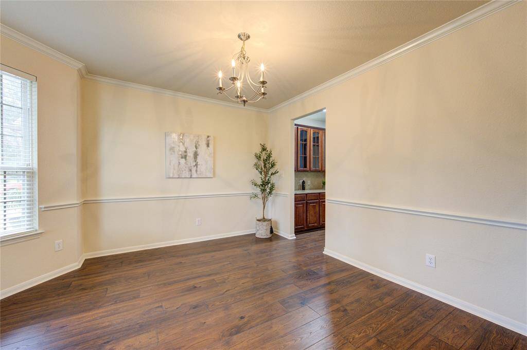 The crown molding adds the hint of elegance that bursts through the dining room. The shades of wall paint embrace and produce warmth throughout the home.