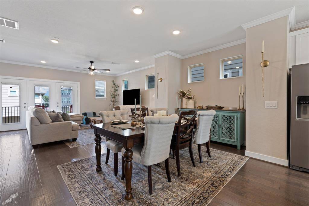 Dining and living area open to kitchen with nice big French doors that open to front balcony. Soaring ceilings, recessed lighting, upgraded designer light fixtures & ceiling fans throughout.  The entire home has a fresh coat of interior paint.