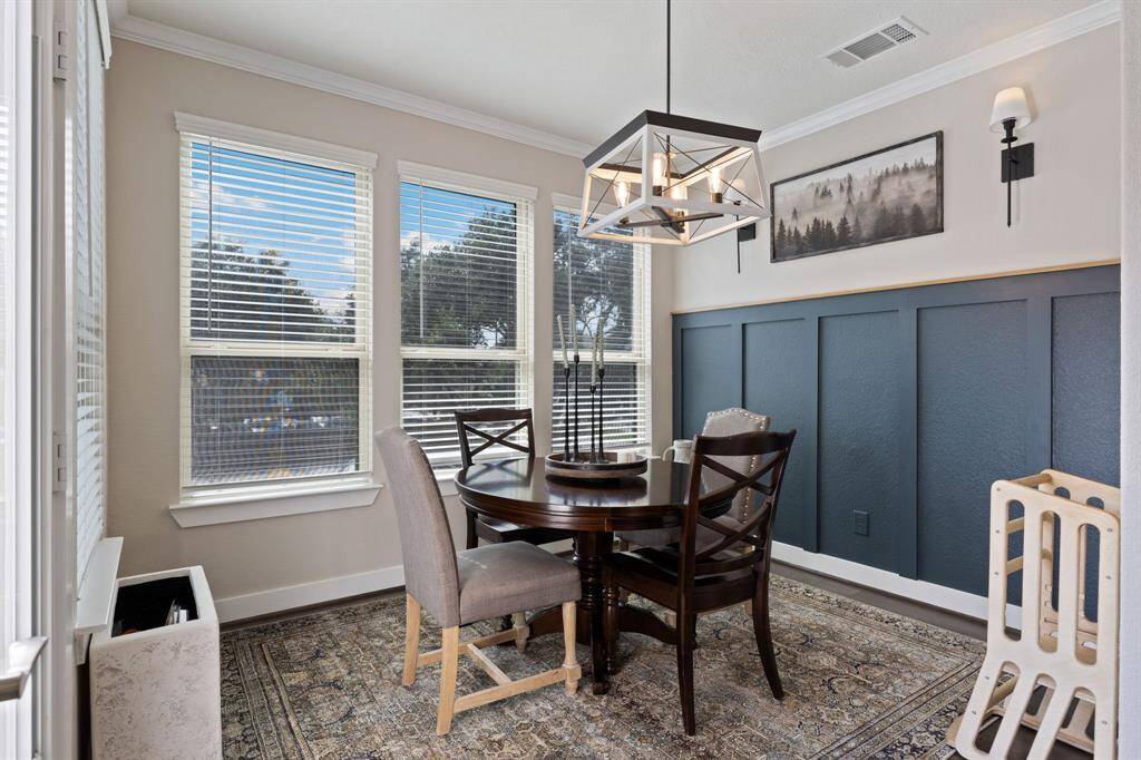 Breakfast room with accent wall, upgraded light fixture leads  to the back balcony.  Double pane window also include solar screens on back side of home.