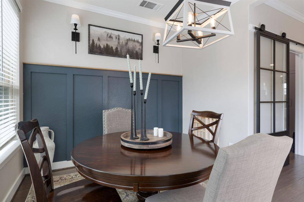 Love the accent wall in the breakfast room.  View of the custom pantry with barn door entry.