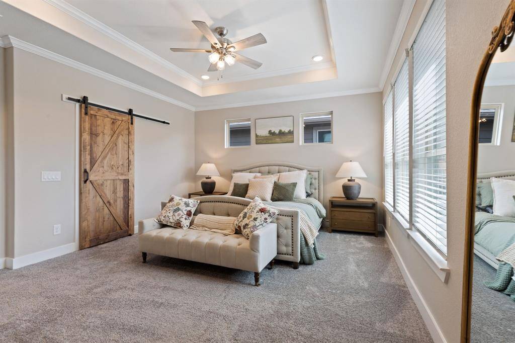 Fresh paint, new carpet, upgraded light fixtures and ceiling fans throughout.  Barn door open to closet with custom cabinetry.