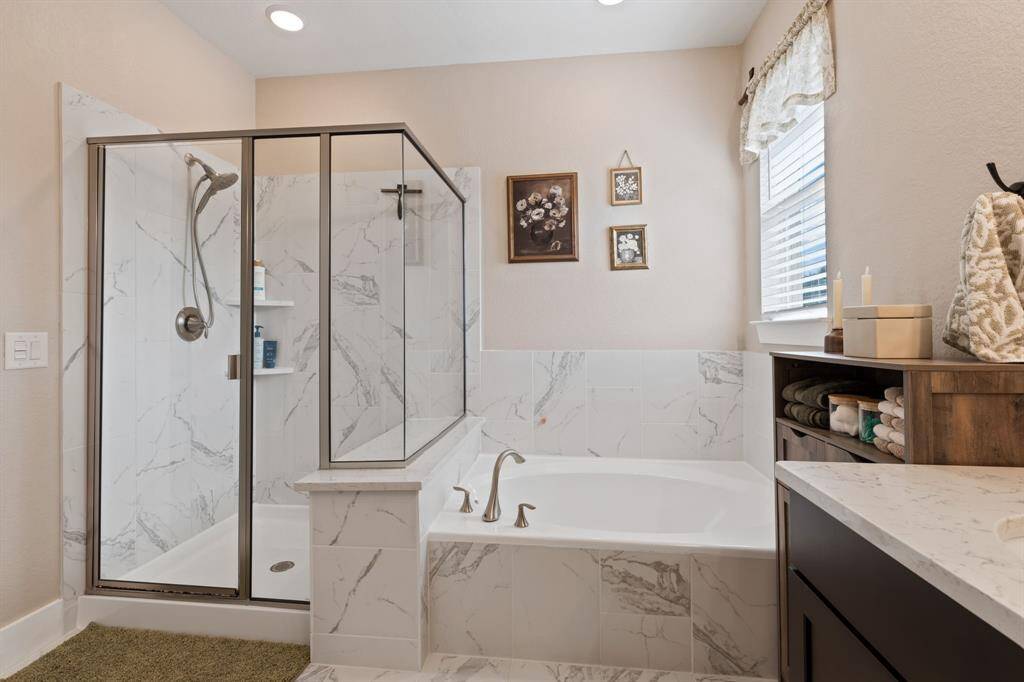 Primary bath with walk-in shower and soaking tub.