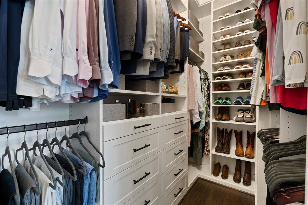 Closet in primary with custom cabinetry.