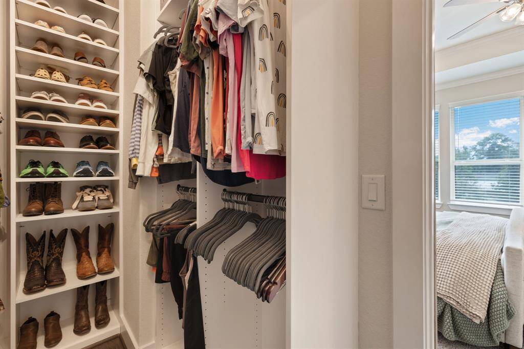 Well-appointed walk-in closet with custom cabinetry in the primary suite.