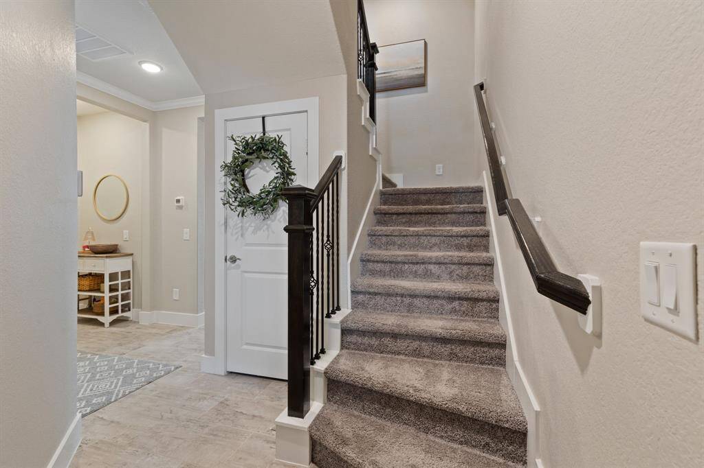 On the first floor you will find a  Huge game room, bedroom & bath with a nice covered tiled patio and yard with low maintenance artificial turf.