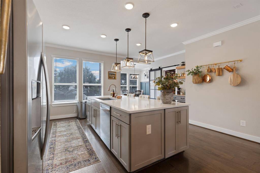 View from kitchen to breakfast area that opens to a nice big back balcony.  Wall of windows for beautiful views.  Entire home has double paned windows.  West facing kitchen windows have solar screens for extra efficiency.