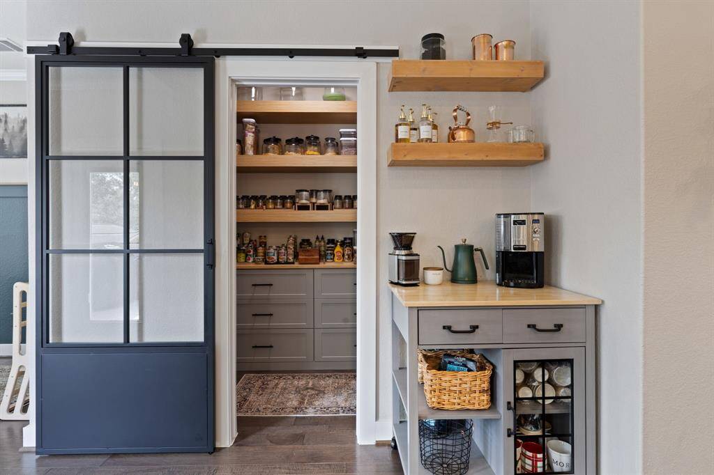 Don't miss this amazing walk-in custom pantry with barn door entry, installed cabinets and drawers!  Includes addtional electrical outlets installed in the cabinets.