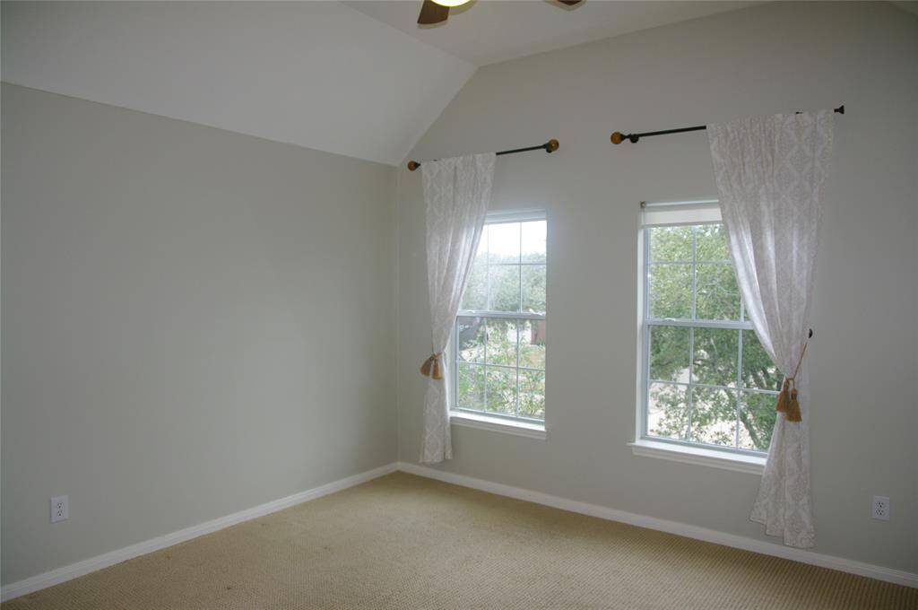Secondary bedroom with high ceiling.