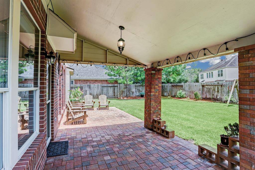 The large covered patio off the breakfast room provides shade for any outdoor activities.