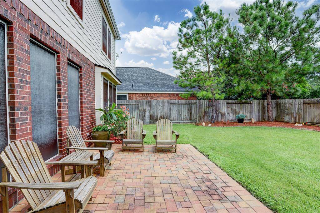 The paver patio extends from the covered patio behind the family room.