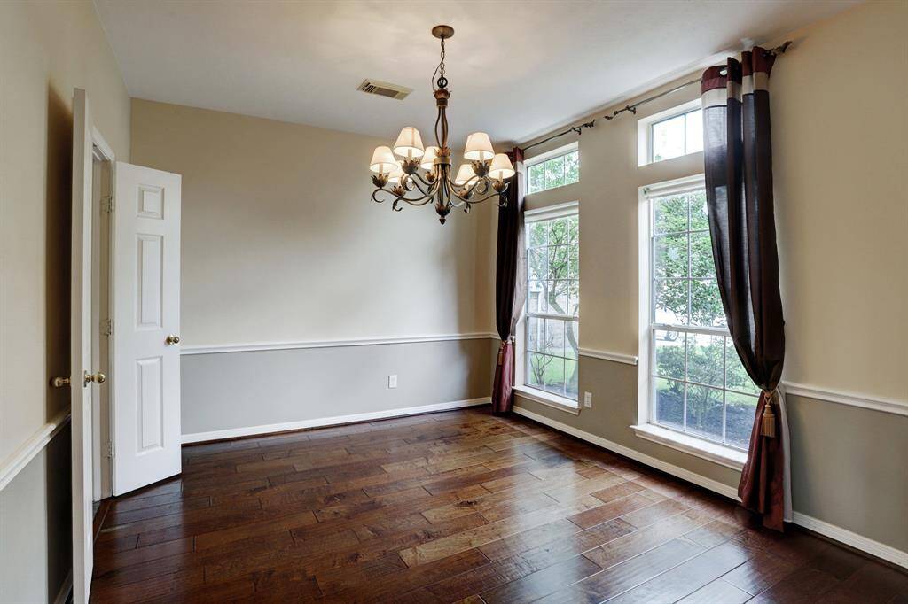 The dining is off the entry and features engineered wood flooring and chair rail molding.