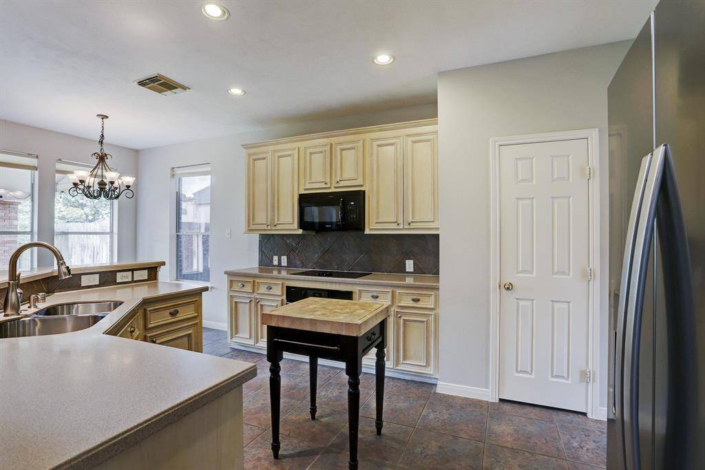 The kitchen opens to the breakfast area and main living room.