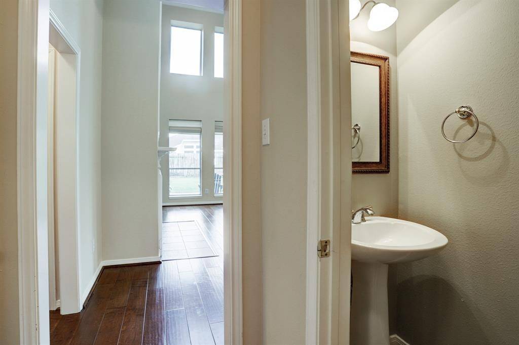 The half bath is conveniently located off the family room close to the utility room.