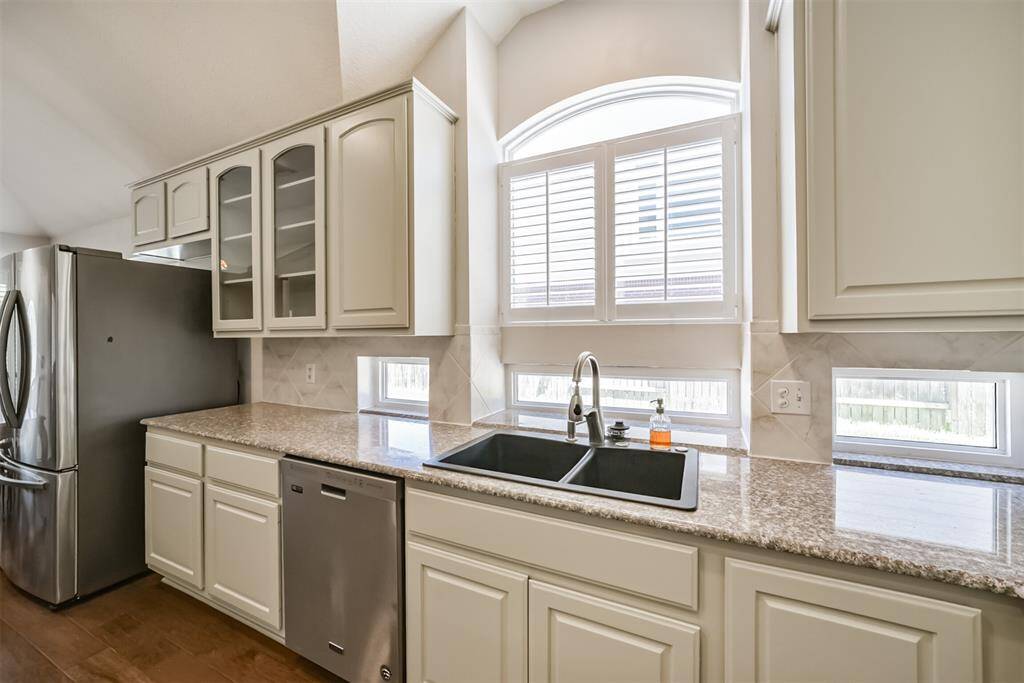 Lots of windows. Cabinets freshly painted with designer color March 2025
