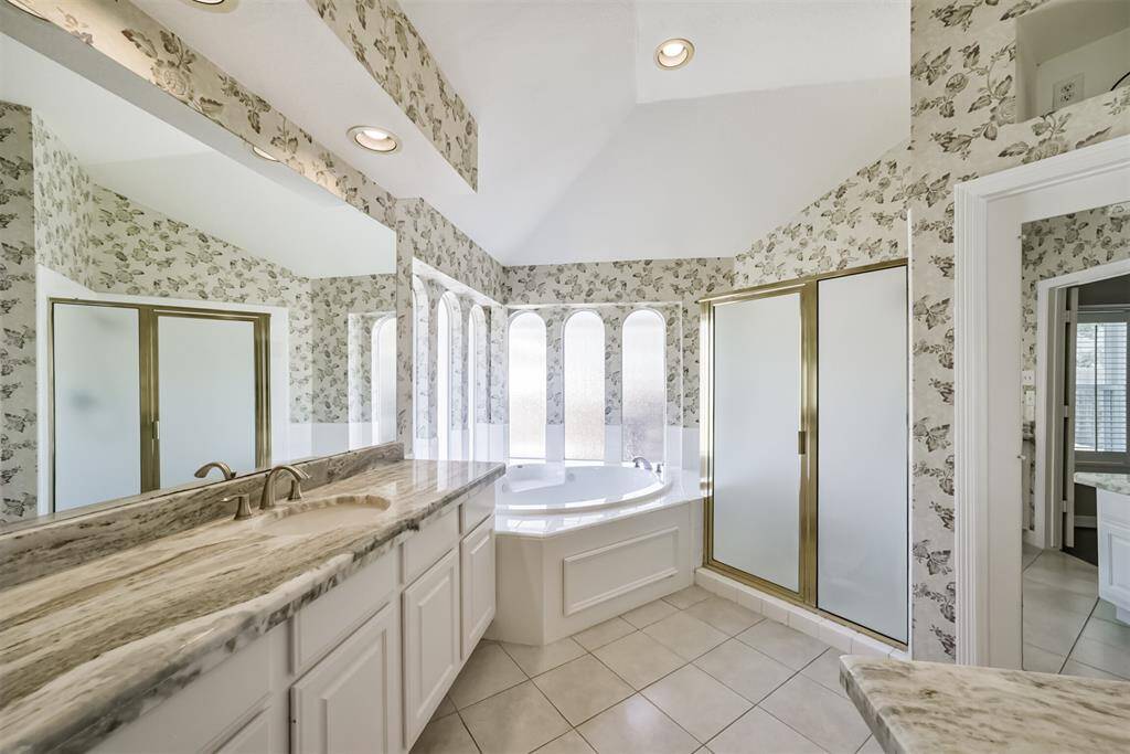 Primary bath has two vanities.