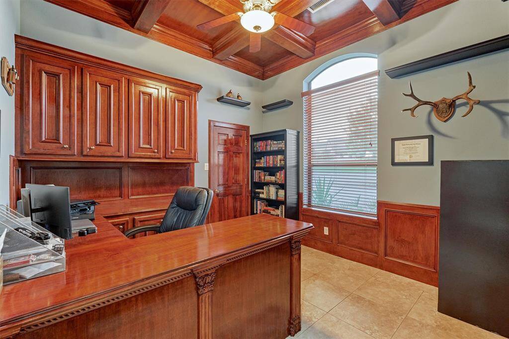 The handsome study is situated at the front of the home. French doors provide privacy.