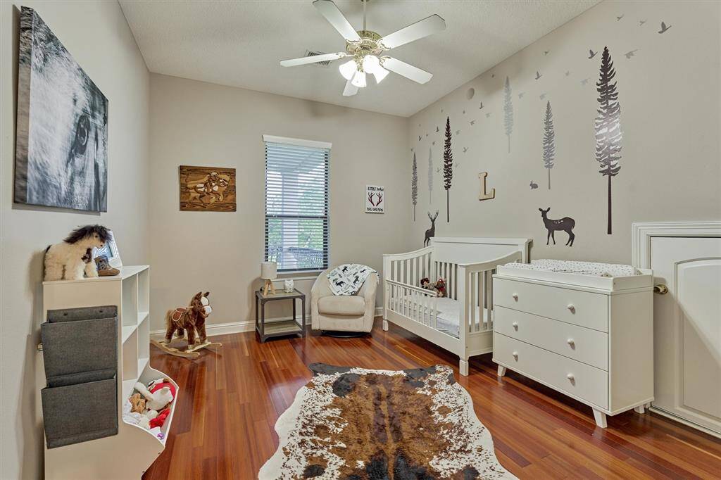 The second upstairs bedroom also features gleaming hardwood floors and a walk in closet.