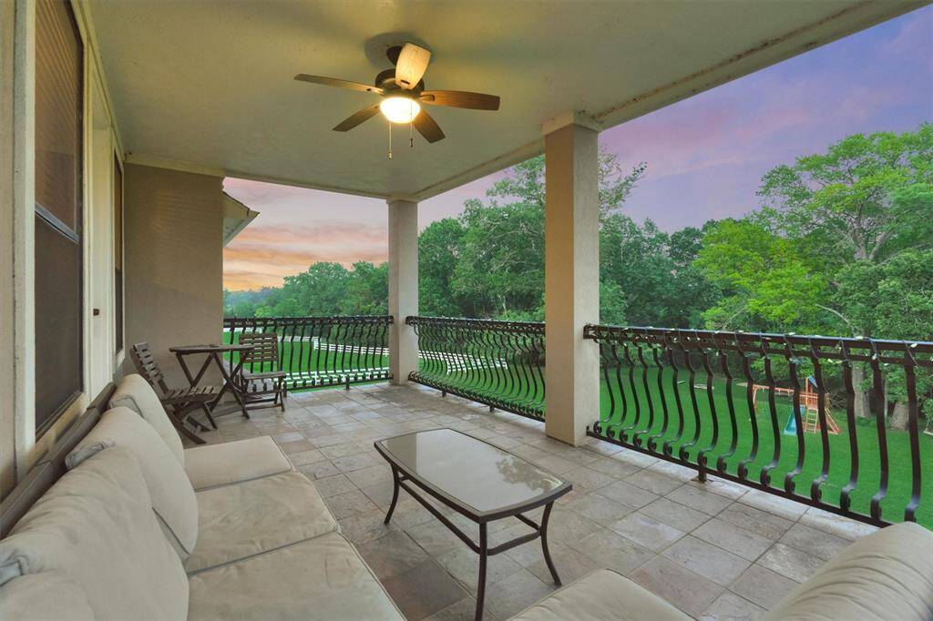 The large balcony located off the game room provides gorgeous views of the property and creek beyond.