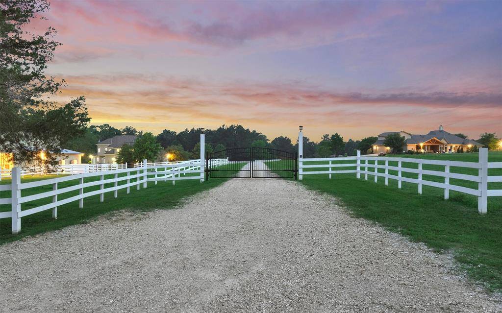 The property may be accessed via the main neighborhood gate or this private, gated drive. From here, you have quick access to highway 105.