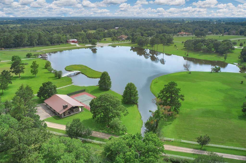 Perfection Ranch is a neighborhood that has much to offer beyond the equestrian amenities! Here we see the private neighborhood lake, tennis court, and covered pavilion.