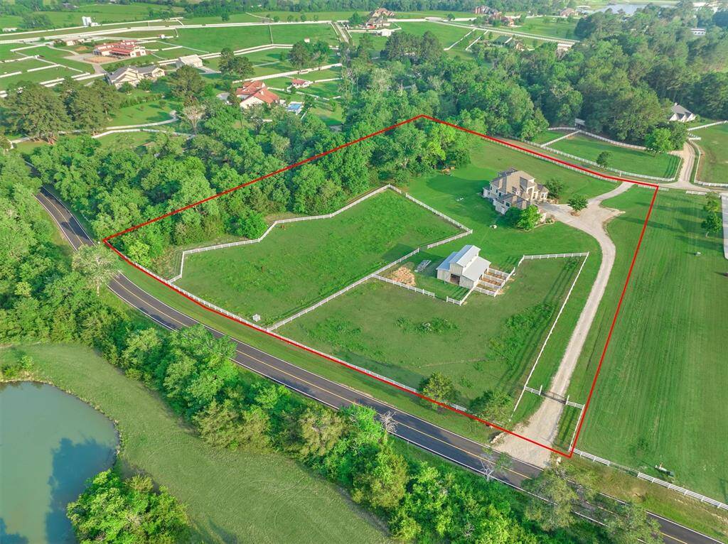 An aerial view showing property lines and surrounding large acre parcels.