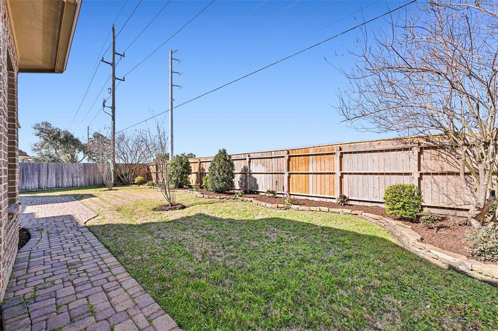 The delightful backyard is landscaped and waiting for you to add your gardening touches to make it your perfect oasis