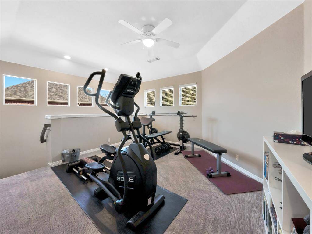 Den is being used as exercise room STAIR access to kitchen from here as well