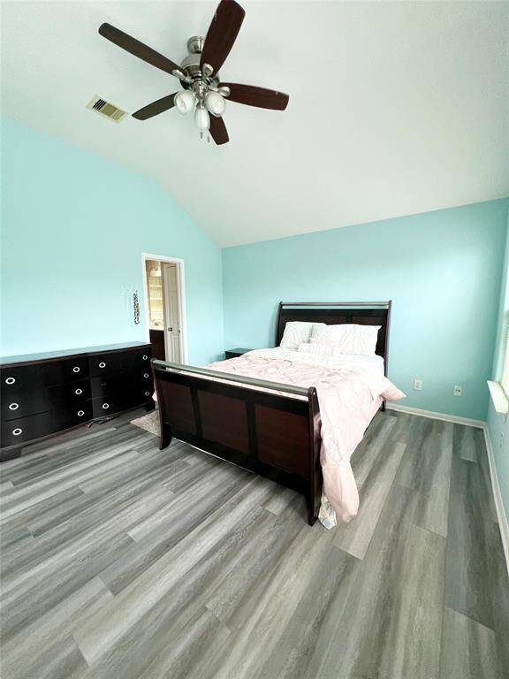 Primary bedroom with high ceilings.