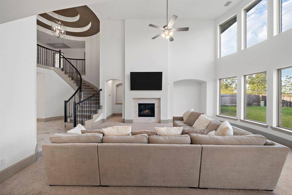 Bright and spacious, the living area flaunts soaring ceilings, expansive windows, and an open layout—perfect for entertaining and creating a welcoming atmosphere.