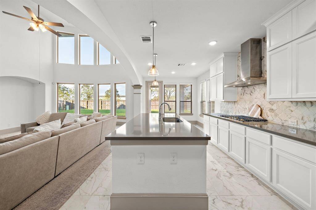 The seamless flow between the living area and kitchen offers an ideal layout for both relaxation and entertaining, along with convenient outdoor access.