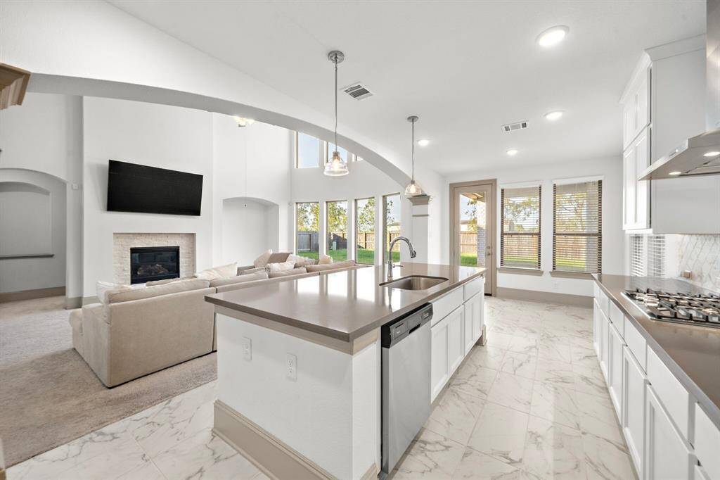 Tasteful and functional, the chef's kitchen boasts elegant granite countertops, multiple cabinets, and stainless steel appliances.