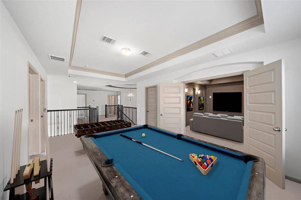 The expansive game room provides a flexible space for entertainment and recreation, with plenty of room for activities, storage, or relaxation, making it a central hub for entertainment with friends and family.