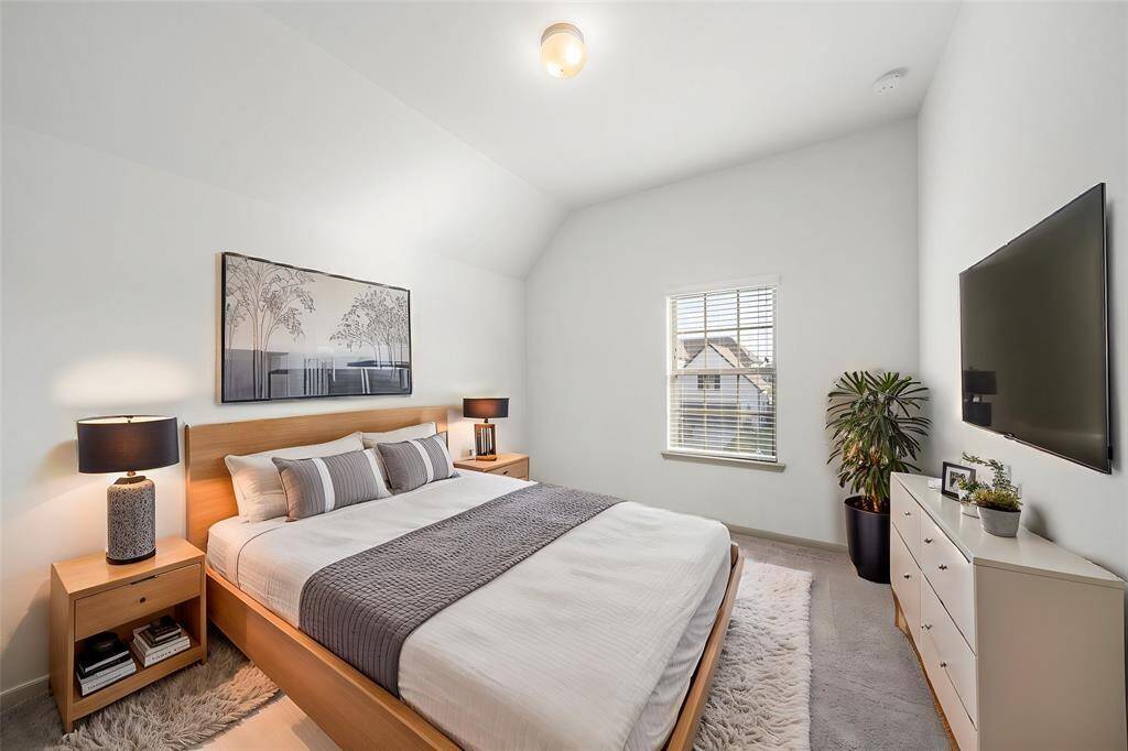 Conveniently situated near the second-floor hallway, this full bath offers a sleek design with a spacious vanity, polished fixtures, and a tiled shower-tub combination.