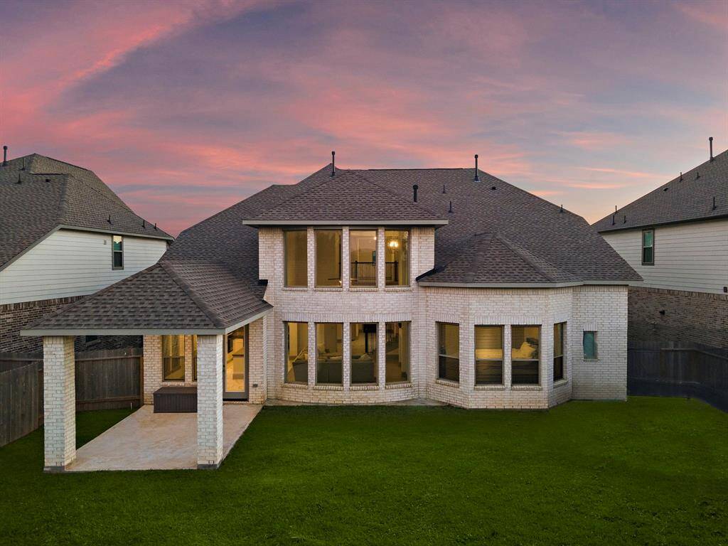 Designed for versatility, the extended patio provides ample room for outdoor dining, grilling, or relaxing, all within the privacy of a fully fenced yard.