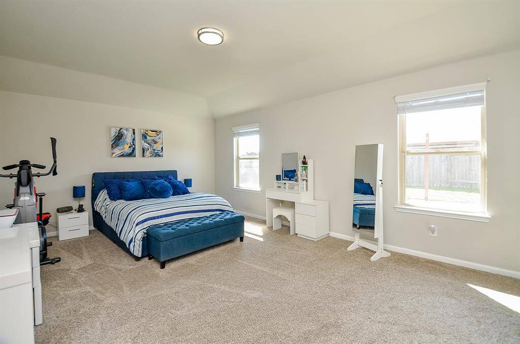 Generously sized master bedroom with enough space for a king-size bed and additional furniture, offering comfort and privacy.