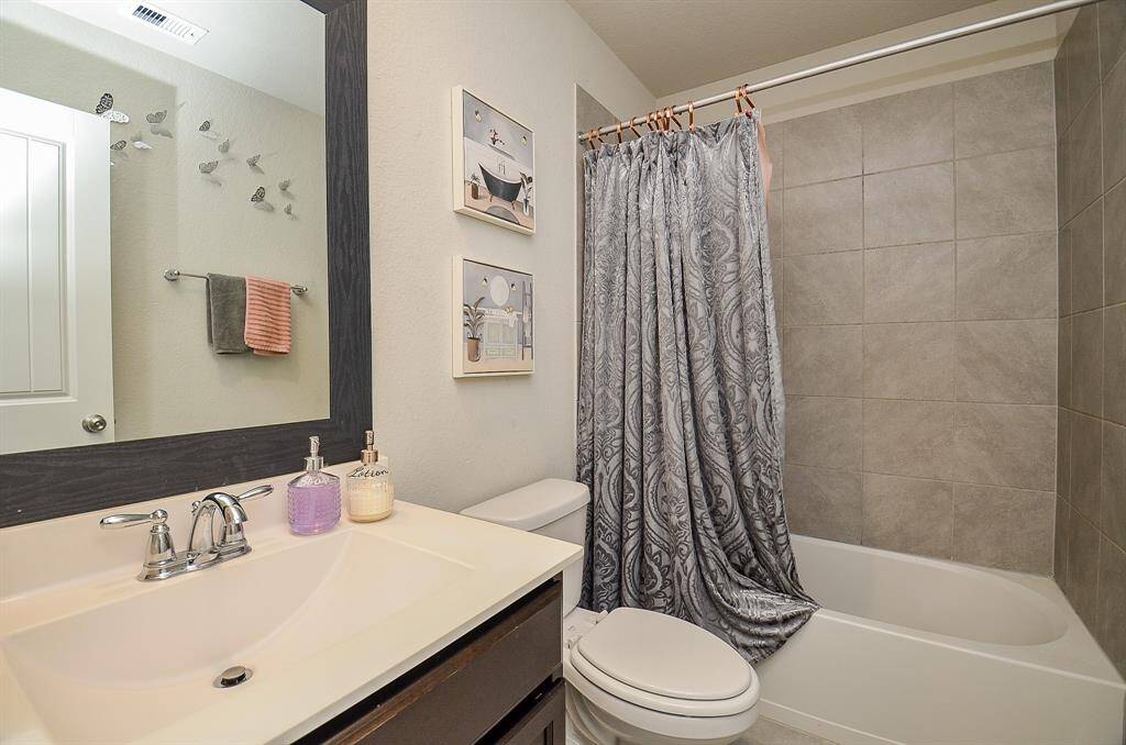 A well-maintained second bathroom with modern fixtures and ample space.
