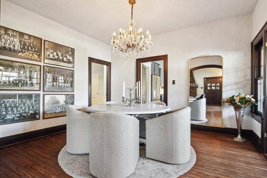The formal dining room is perfect for gatherings Note the beautiful chandelier and rich wood floors and mill work.