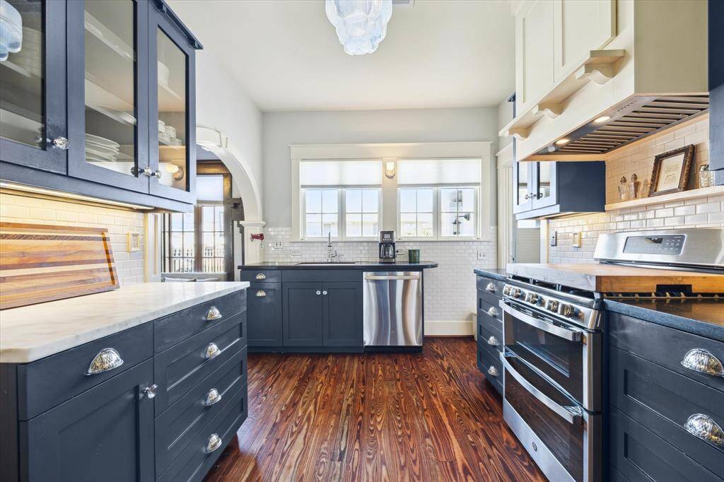 This view shows the elegant glass front cabinets. Many original elements have been restored from the 1920s including blue light chandeliers.