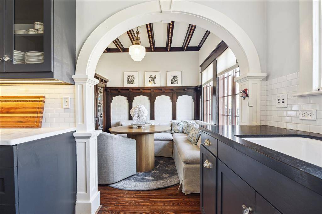Focus on all of the millwork as you enter the breakfast room. The grand arch, wall pillars and beamed ceiling with inlays.