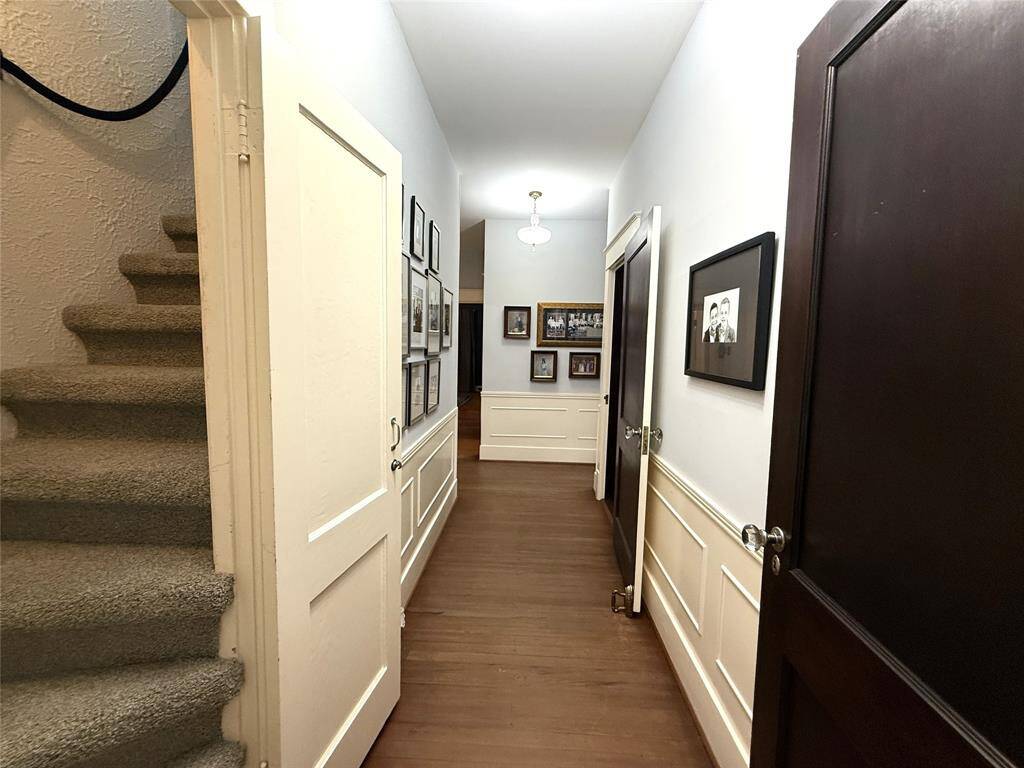The central hall allows for access from the living to the upstairs, dining room, pantry closet, kitchen, middle bedroom and the primary bedroom suite.