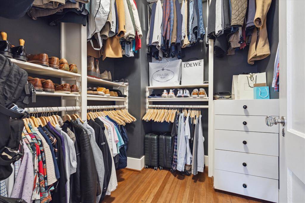 The well organized walk-in closet features pull down racks, built-in dresser and plenty of storage.